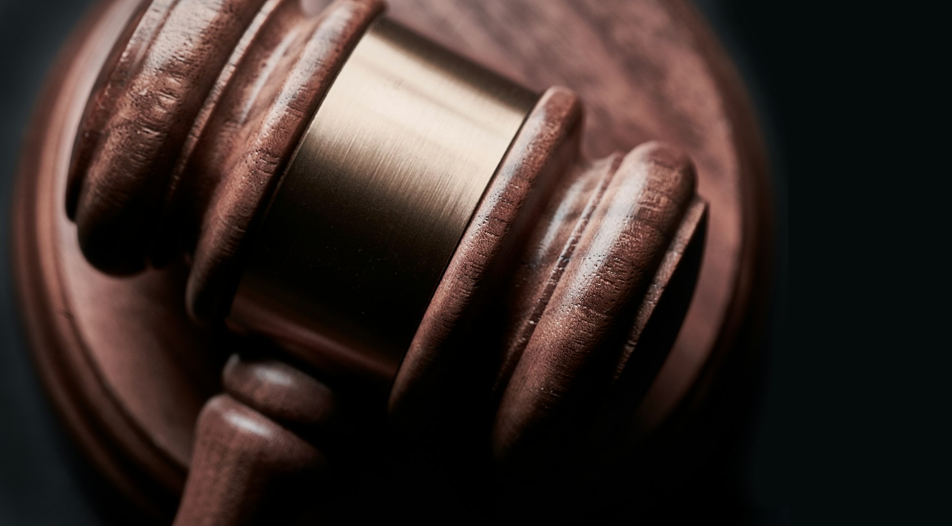 Close-up of a wooden gavel and sound block on a judge's desk