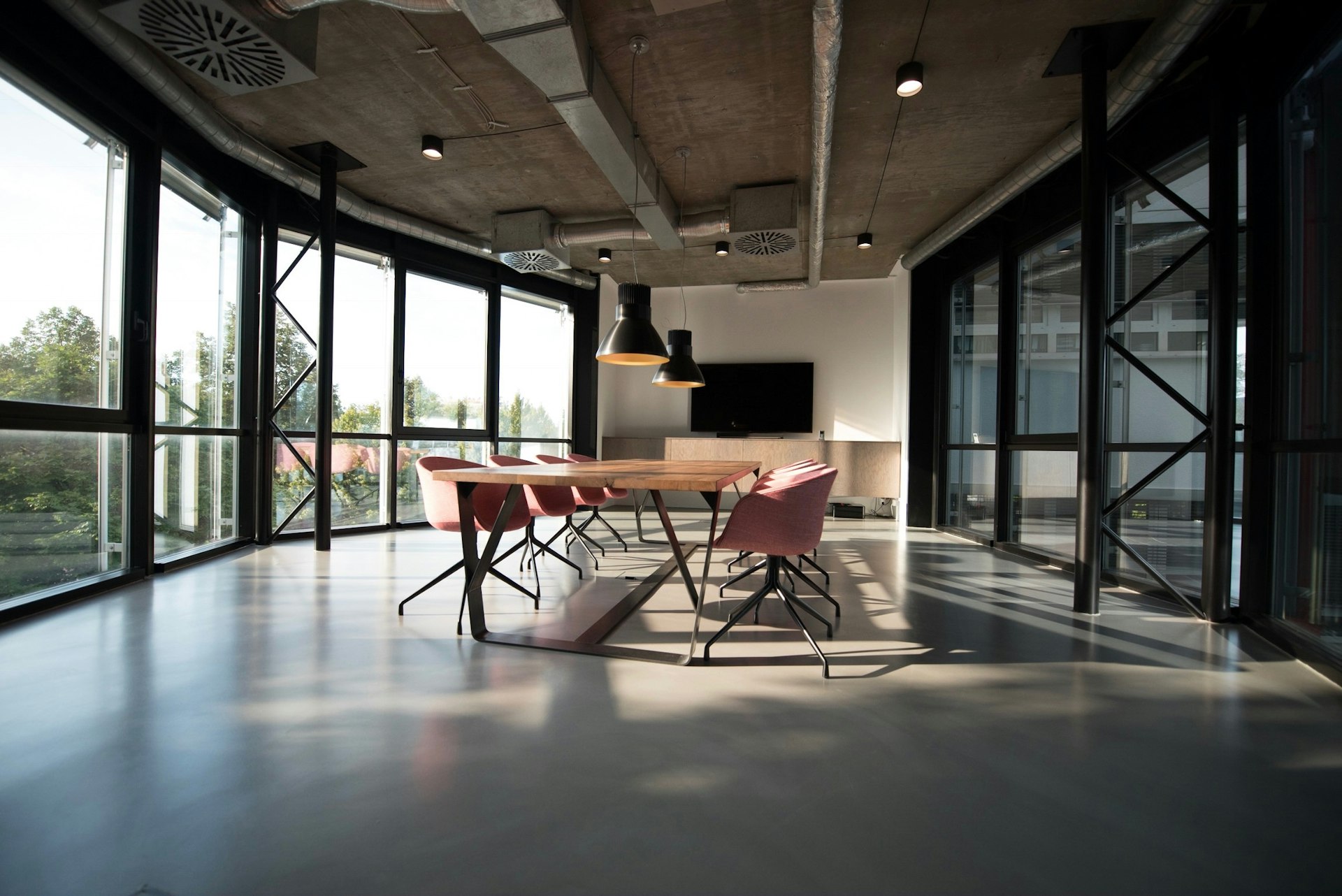 Minimalist corporate boardroom overlooking city skyline at dusk